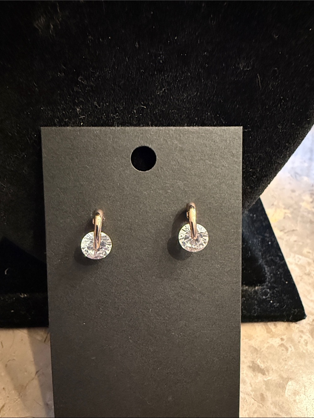 NWOT rose gold colored cubic Zirconia spinning pierced earrings, floating design